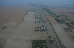 Small community near launch site in Arabian desert from hot air balloon