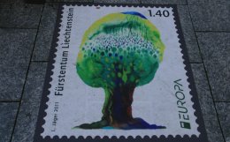 Large Liechtenstein postage stamp on the sidewalk