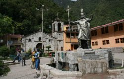 Statue of Pachacutec and town cathedral from the main square in Aguas Calientes